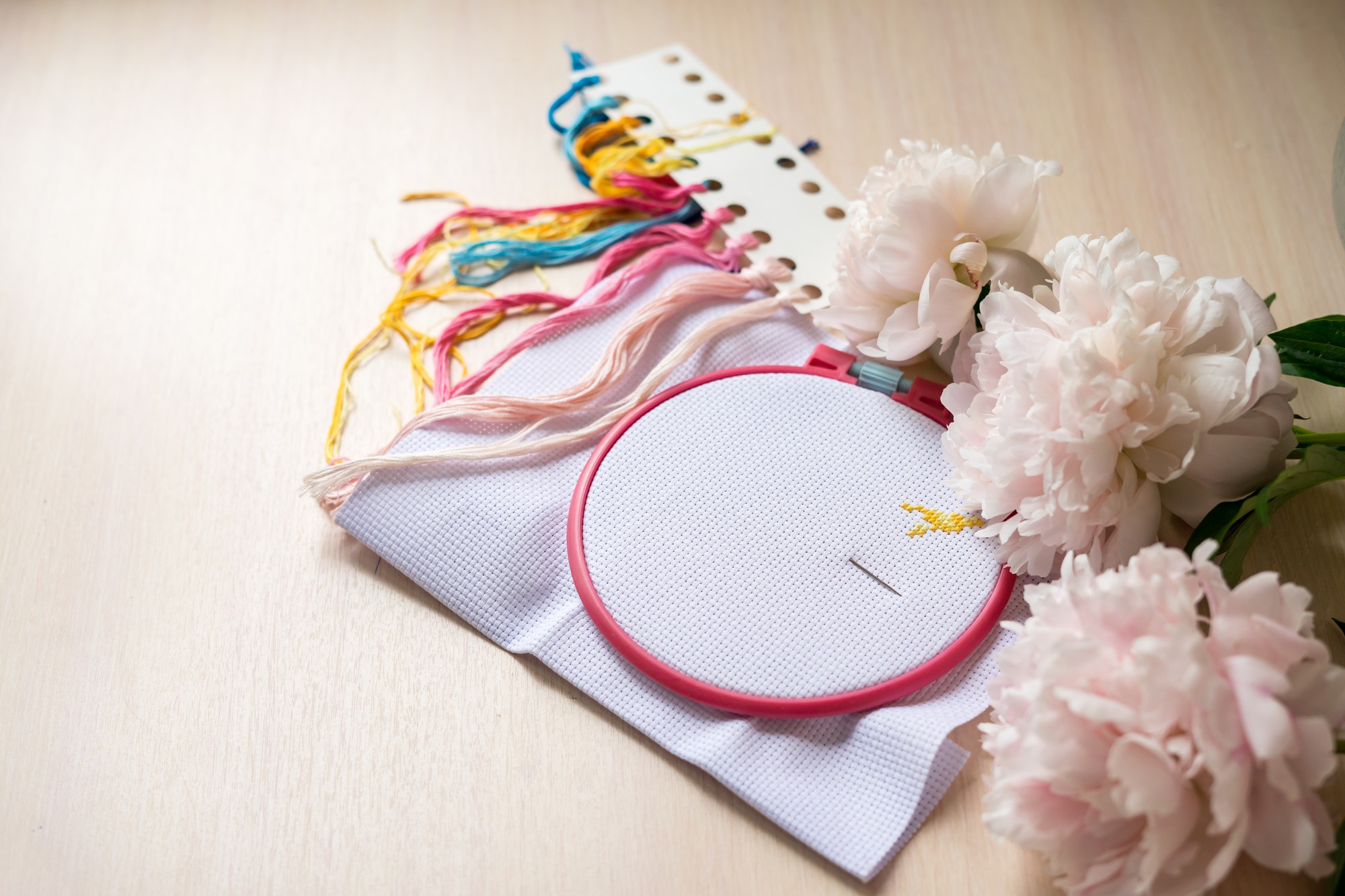 Close-up of colorful hand embroidery on linen